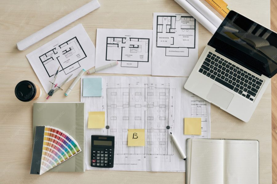 Pozycjonowanie architekta wnętrz — biurko z próbkami materiałów i rysunkiem projektu wnętrza